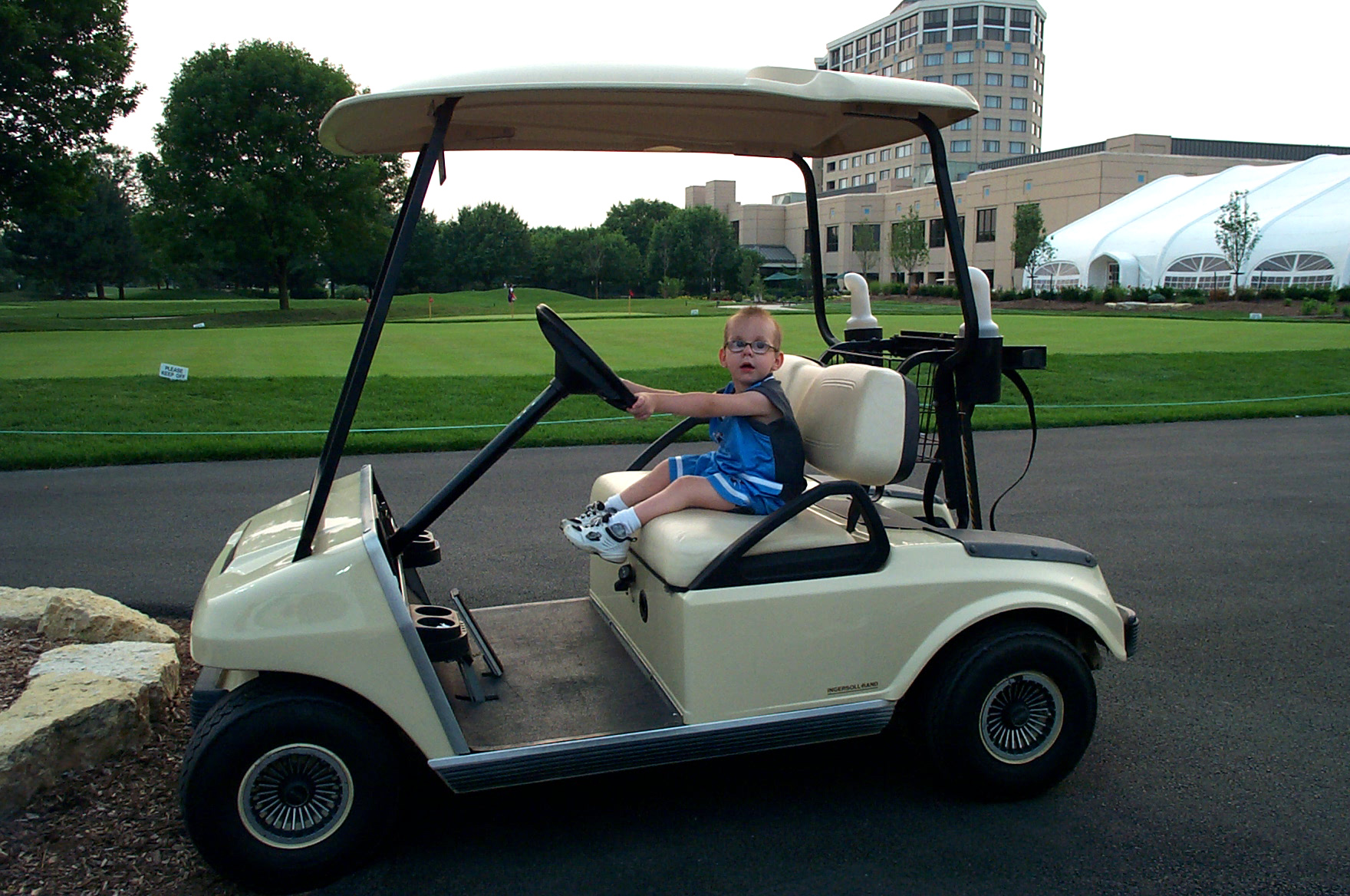 young man play driving a golf cart