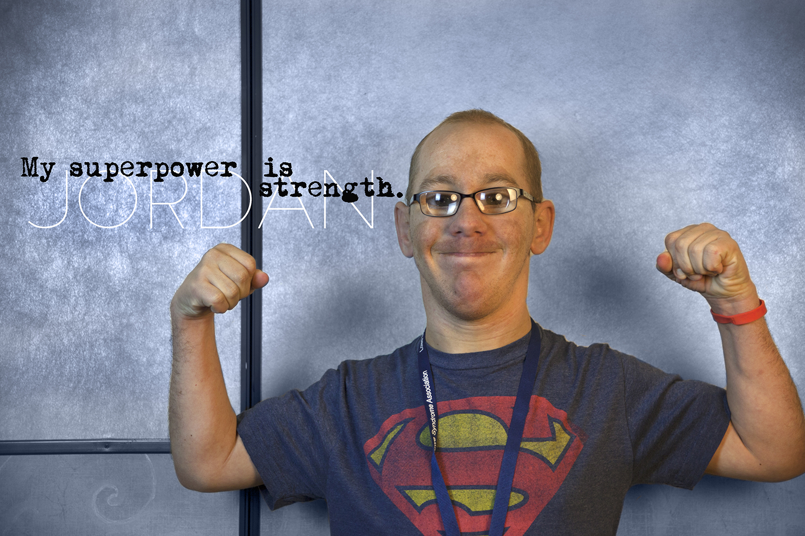 Young man with Lowe syndrome flexing showing his strength